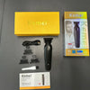 A set of Kemei professional cordless electric hair clippers, including the main unit and accessories, displayed on a dark sur