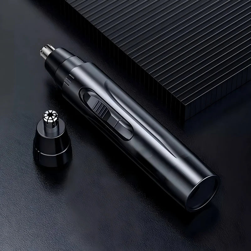 A sleek black professional electric nose and ear hair trimmer lying on a dark surface.
