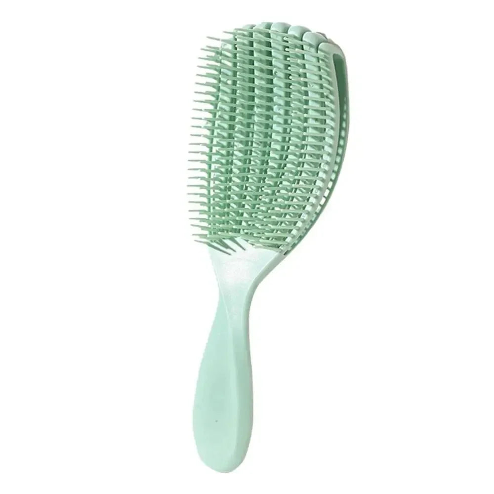 A light green massage detangler hair brush with fine teeth shown against a white background.