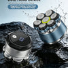 A silver magnetic floating electric head shaver is shown in a close-up against a dark, wet surface.