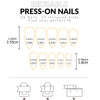 A set of reusable press-on nails in various sizes and shapes displayed with a ruler for scale.