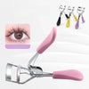 A silver eyelash curler with pink handles and multiple tips is shown alongside a close-up of curled eyelashes.