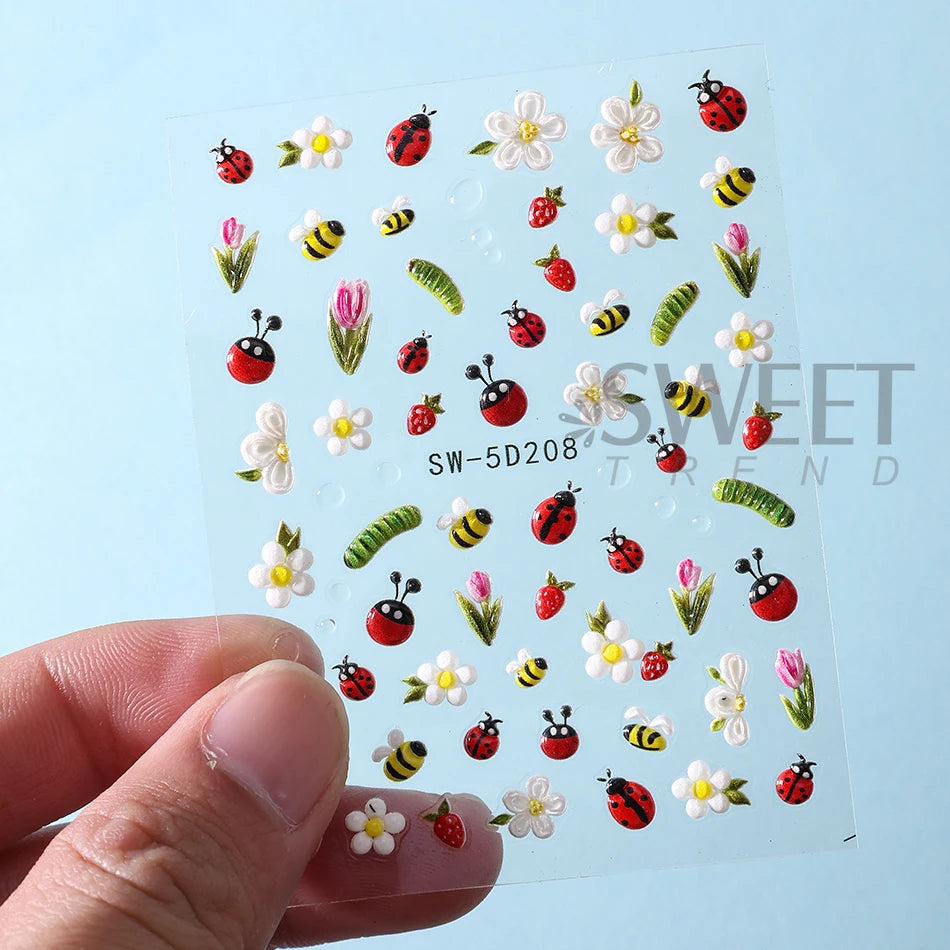 A sheet of embossed floral nail art stickers featuring various spring designs like flowers, insects, and leaves.