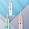 Three colors of a portable oral irrigator dental water flosser displayed against a light blue background.