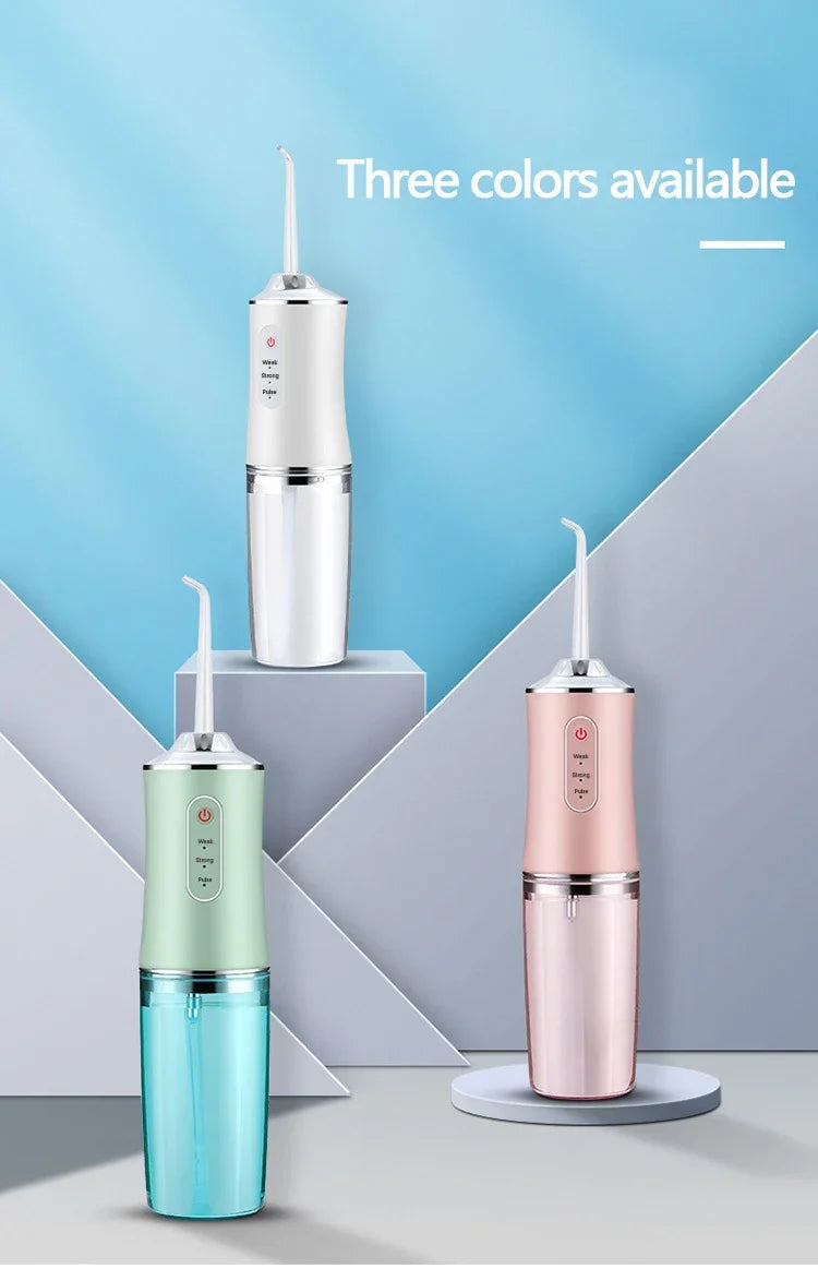 Three colors of a portable oral irrigator dental water flosser displayed against a light blue background.