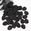 A pile of black latex-free finger puffs for flawless makeup application.