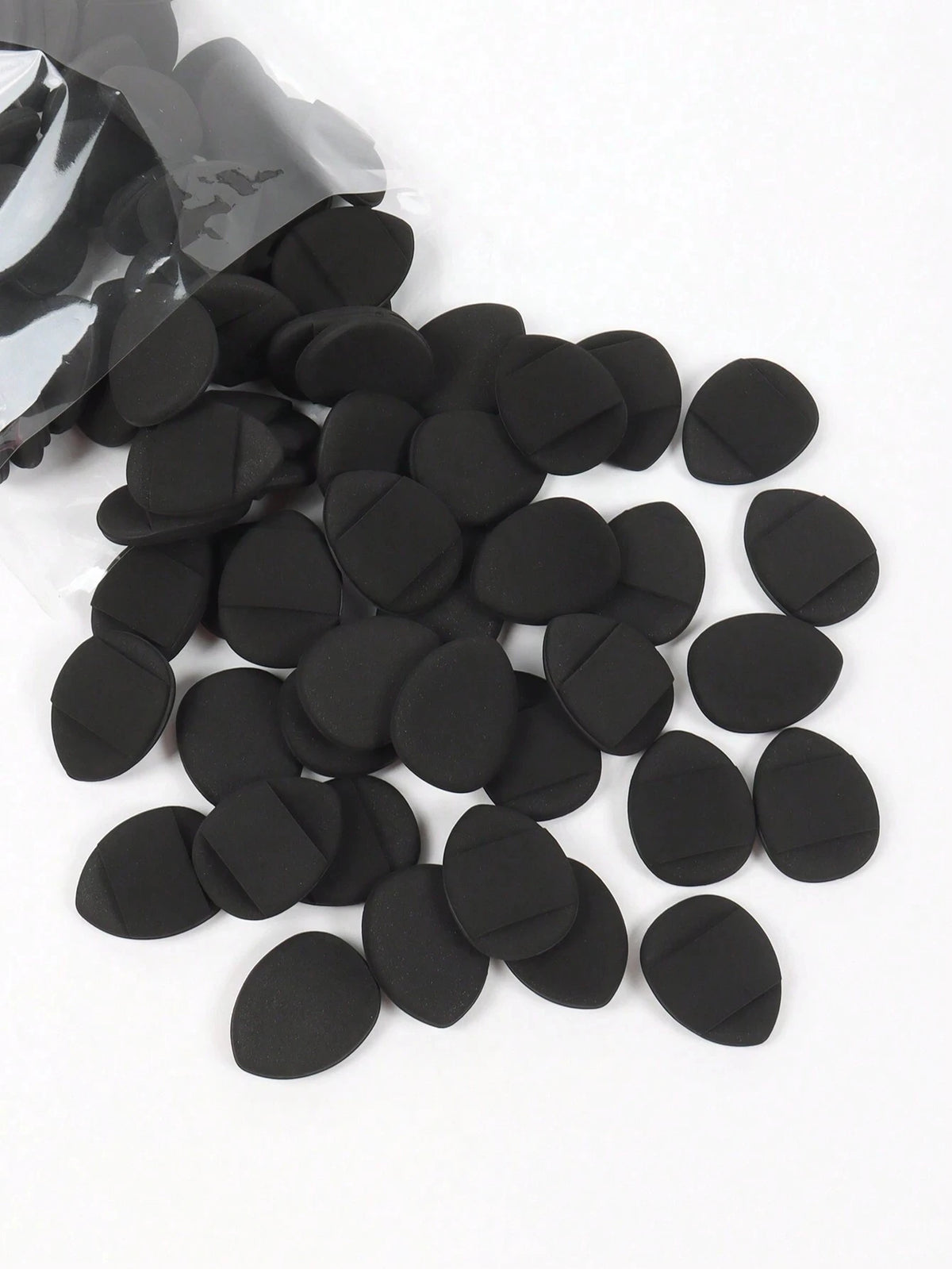 A pile of black latex-free finger puffs for flawless makeup application.