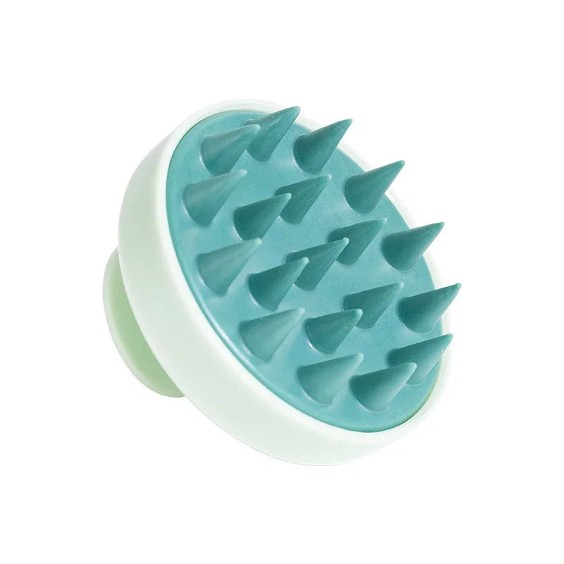 A light blue silicone scalp massage and body brush with a white handle.