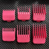 A collection of pink electric hair clipper guards with various sizes and teeth.