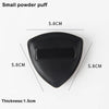 A black triangular cosmetic foundation puff brush with a thickness of 1.5cm.