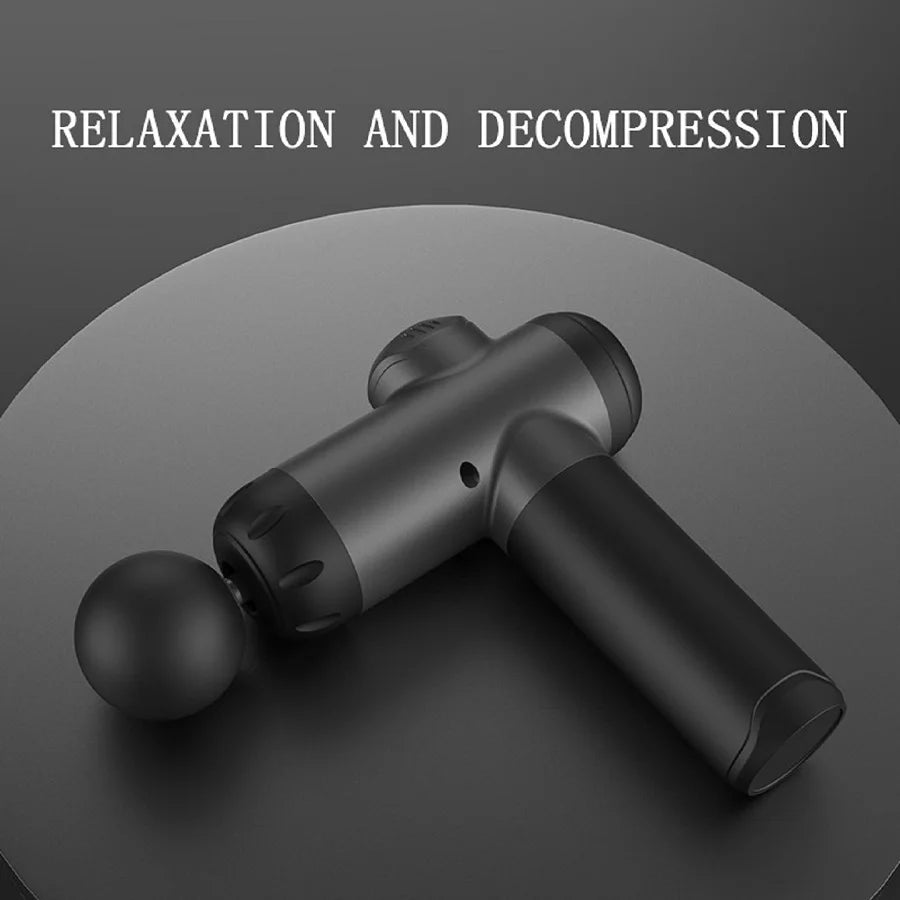 A black deep tissue massage gun with a spherical head is shown on a dark surface.