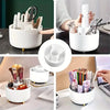 A white 360 degree rotating makeup organizer holding various brushes and tools for cosmetics.