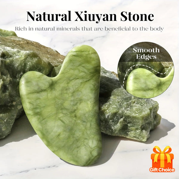 A smooth, light green jade stone is shown next to rougher pieces on a white marble surface.