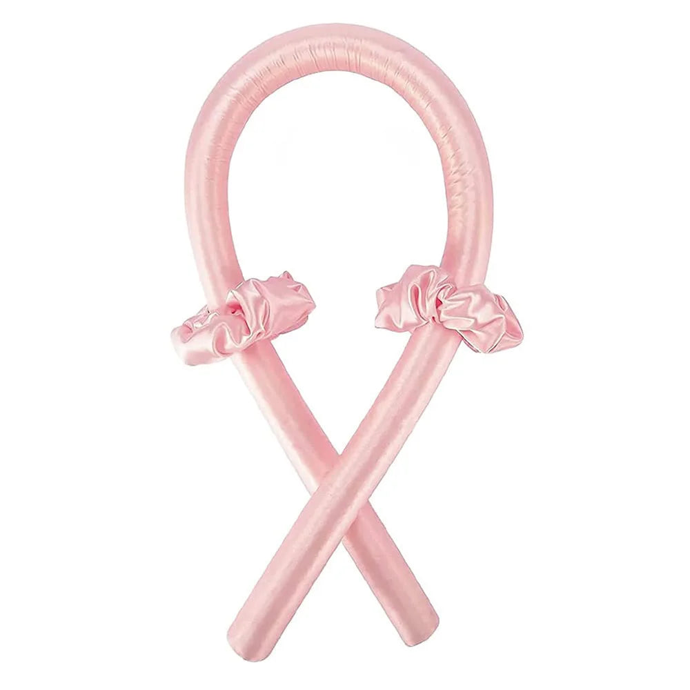 A pink satin heatless curling set shaped like an 'X' with decorative bows.