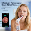 A blonde woman is using a white precision tonsil stone remover device with an HD camera to clean her tonsils.