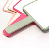 Miroir de maquillage portable compact avec poignée dans diverses nuances pastel de rose, beige et vert.