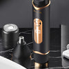 A black electric body hair trimmer in a gold-accented casing is shown next to its detachable head on a dark marble surface.
