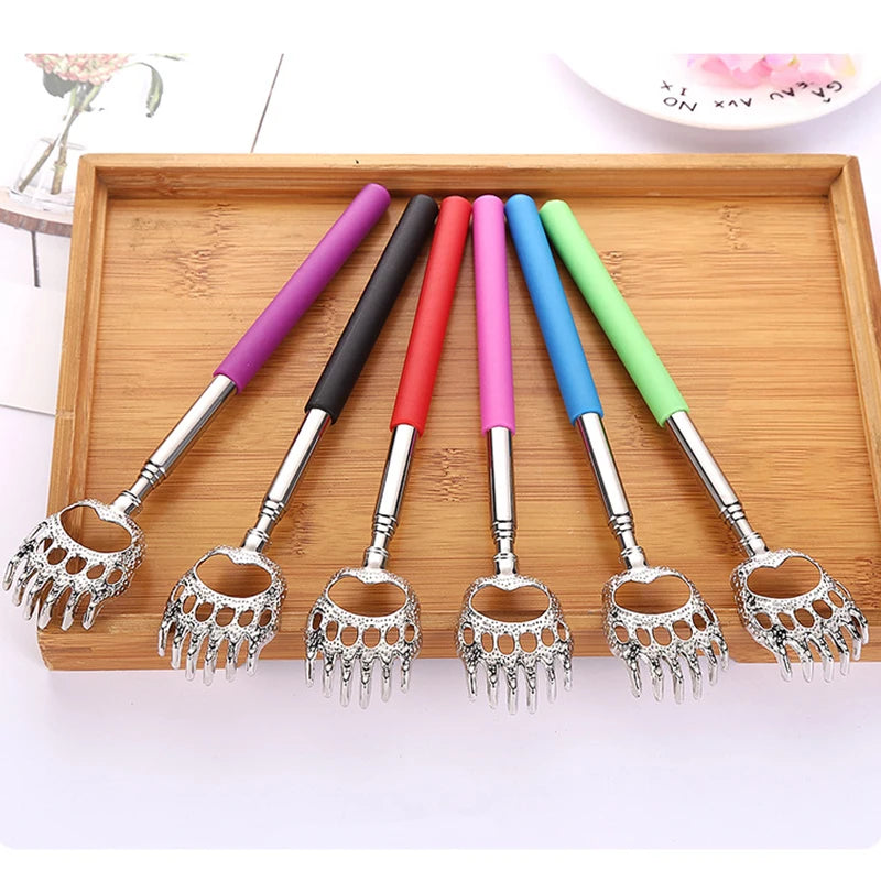 A set of six colorful stainless steel telescopic back scratchers with retractable handles displayed on a wooden tray.