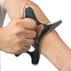A hand holds a stainless steel gua sha massage tool against the skin of an arm.