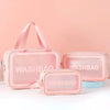 A set of pink transparent PVC cosmetic storage bags, including a large pouch and a smaller case.