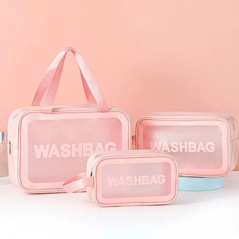 A set of pink transparent PVC cosmetic storage bags, including a large pouch and a smaller case.