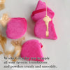 Pink triangular velvet powder puff with a gold applicator for applying foundations and powders