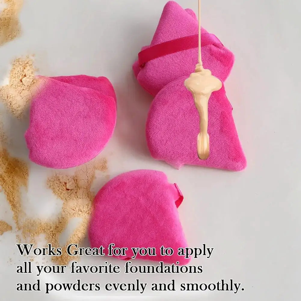 Pink triangular velvet powder puff with a gold applicator for applying foundations and powders