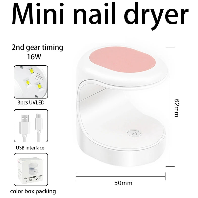 A white mini nail dryer with a pink heating element and various accessories shown in a box packaging.