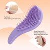 A purple detangling scalp massage hairbrush is shown with a close-up of the bristles and a hand holding the handle.