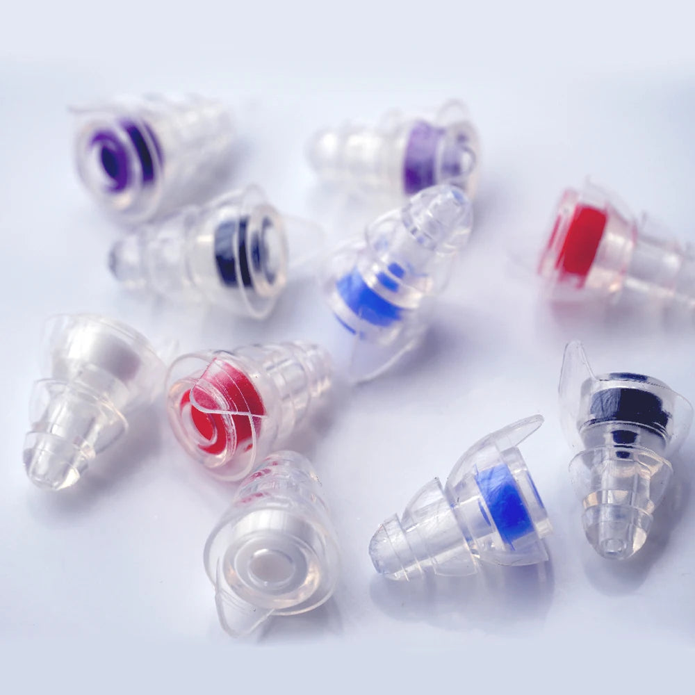 Several silicone earplugs in various colors including purple, blue, and red are shown with their storage cases.