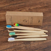 A box containing a set of ten natural bamboo toothbrushes is displayed on a wooden surface.