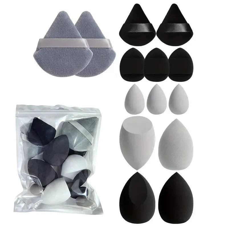 Un ensemble de tampons de maquillage et de puffs en poudre à nuances gris et noir.