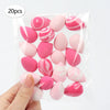 A hand holds a clear plastic bag filled with 20 pink and white reusable expandable makeup sponges.