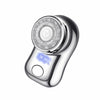 A close-up view of a silver cordless electric beard trimmer shaver with a rotating head and a blue indicator light.