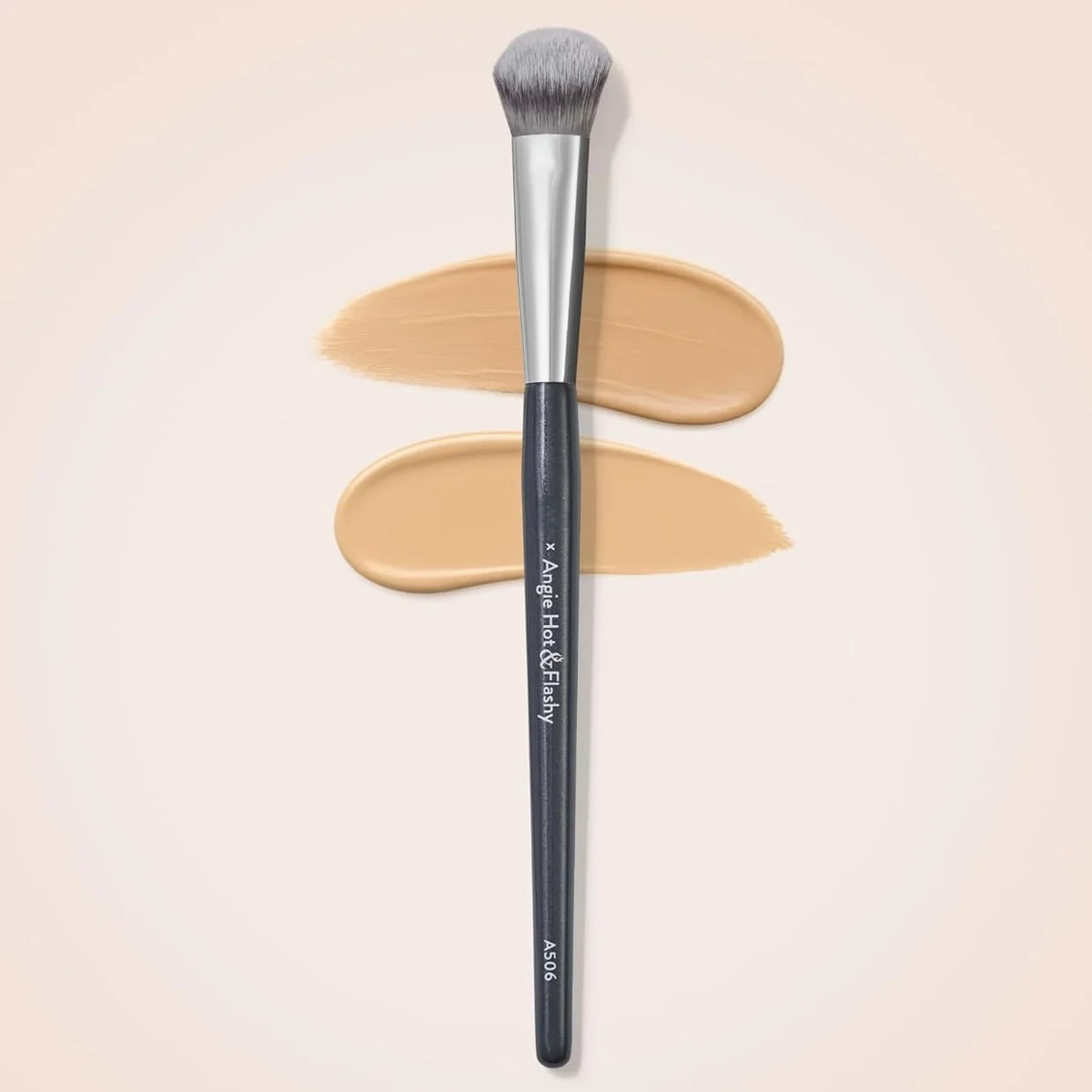 A precision concealer brush with a black handle and grey bristles is shown against a light background.