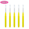 A set of five yellow mini brow and eyelash combs.
