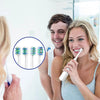 A woman is shown brushing her teeth with a toothbrush head, with another person and a magnified view of replacement brush hea