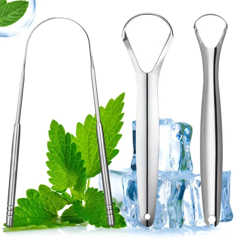 A set of three stainless steel tongue scrapers resting on fresh green mint leaves.