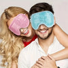 A man and woman smiling while wearing reusable gel eye masks for migraine relief.