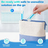 A hand is placing a packet of nasal rinse saline solution into a beige travel pouch for on-the-go use.