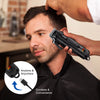 A man is using a black Hiena cordless hair trimmer on his head, demonstrating its convenience.