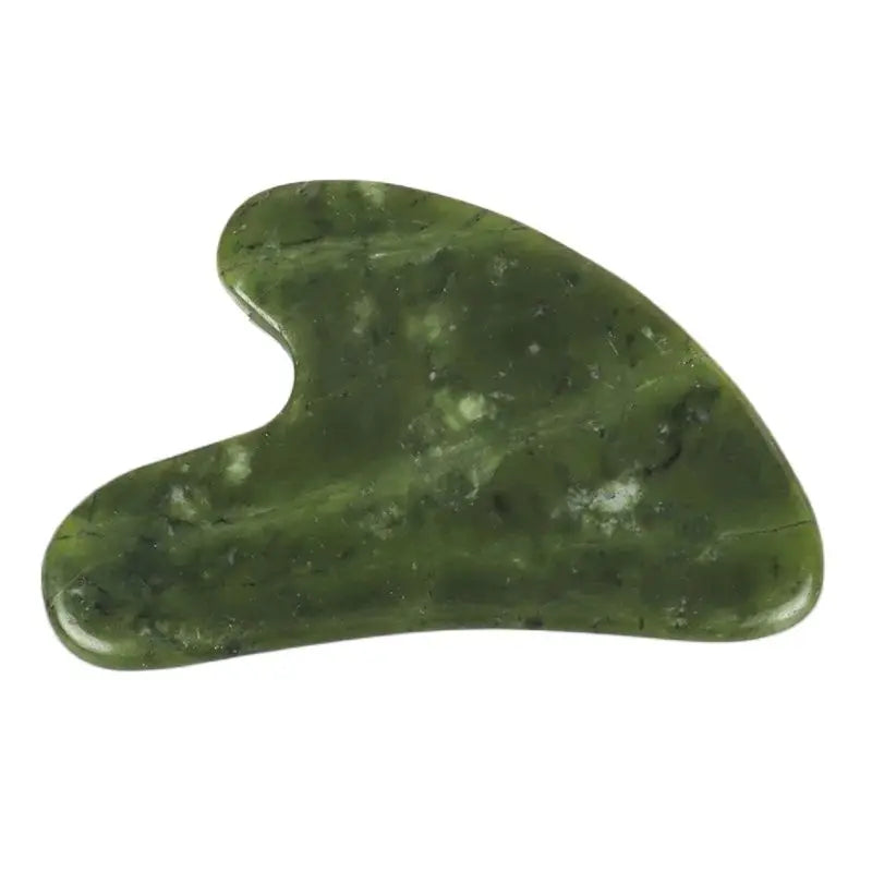 A smooth, oval-shaped piece of green jade used as a gua sha tool for facial massage.