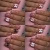 A set of leopard print press-on nails featuring various shades and designs on a hand.