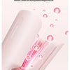 A pink professional beach waver curling iron is shown with steam or ions emanating from the tip.