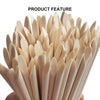A close-up of natural wood nail art pusher sticks arranged in a fan shape.