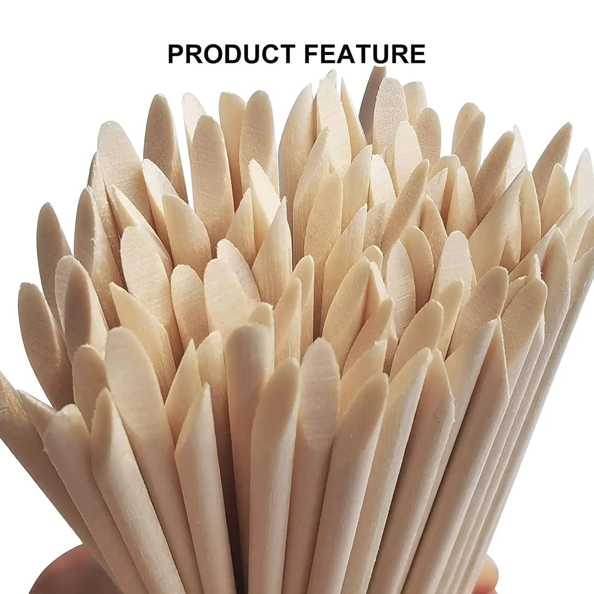 A close-up of natural wood nail art pusher sticks arranged in a fan shape.