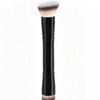 A black makeup foundation brush with a soft pink bristles shown vertically.