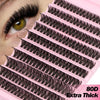 A close-up of a pink lash tray showing various natural wispy lash clusters for eye makeup.