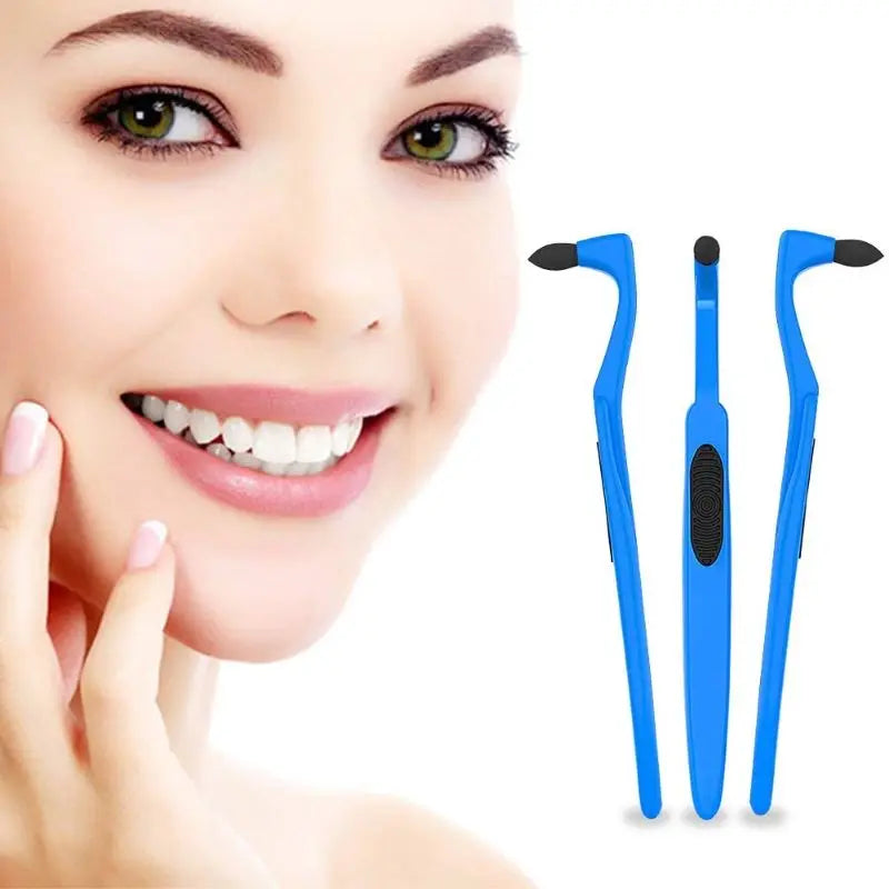 A close-up of a woman smiling while holding a manual tooth stain remover with an interdental brush tool.