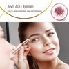 A woman is using an automatic electric eyebrow trimmer on her eye area.